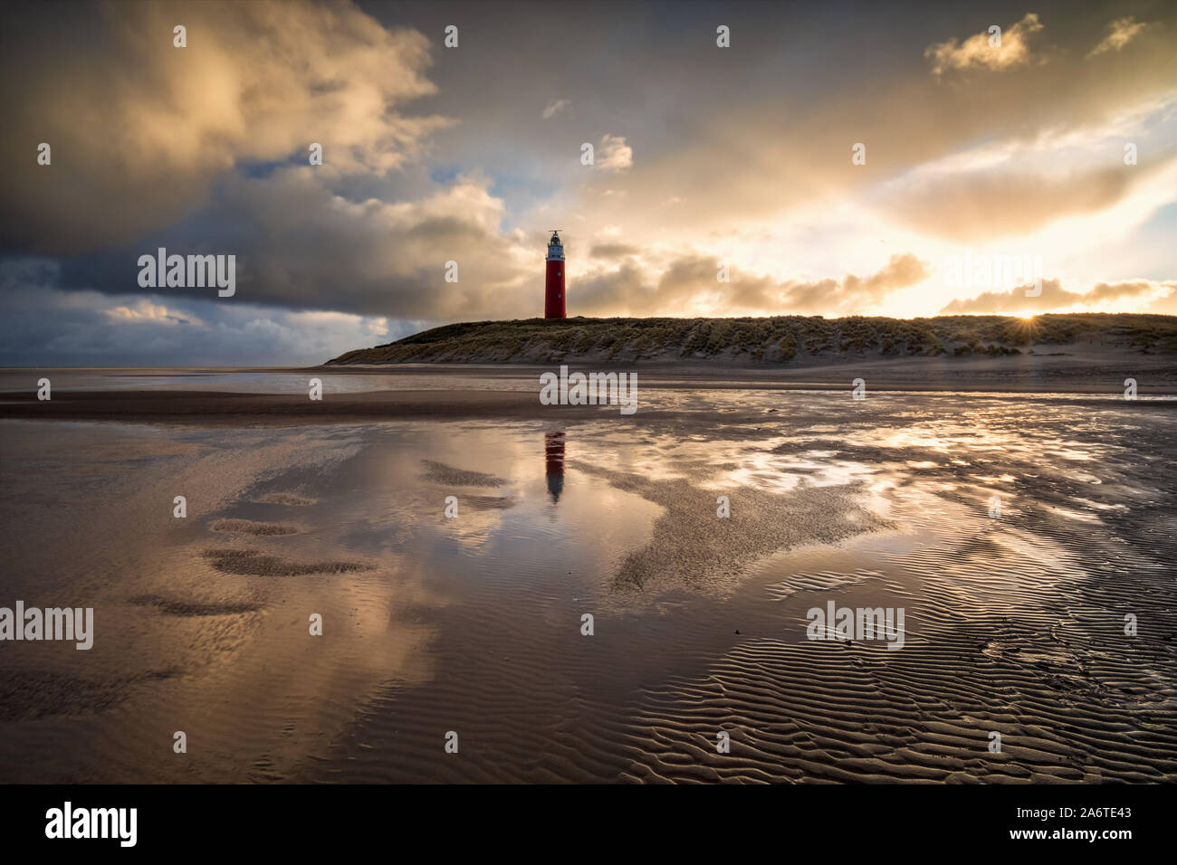 dramatic sunrise behind lighthouse on north sea coast Stock Photo
