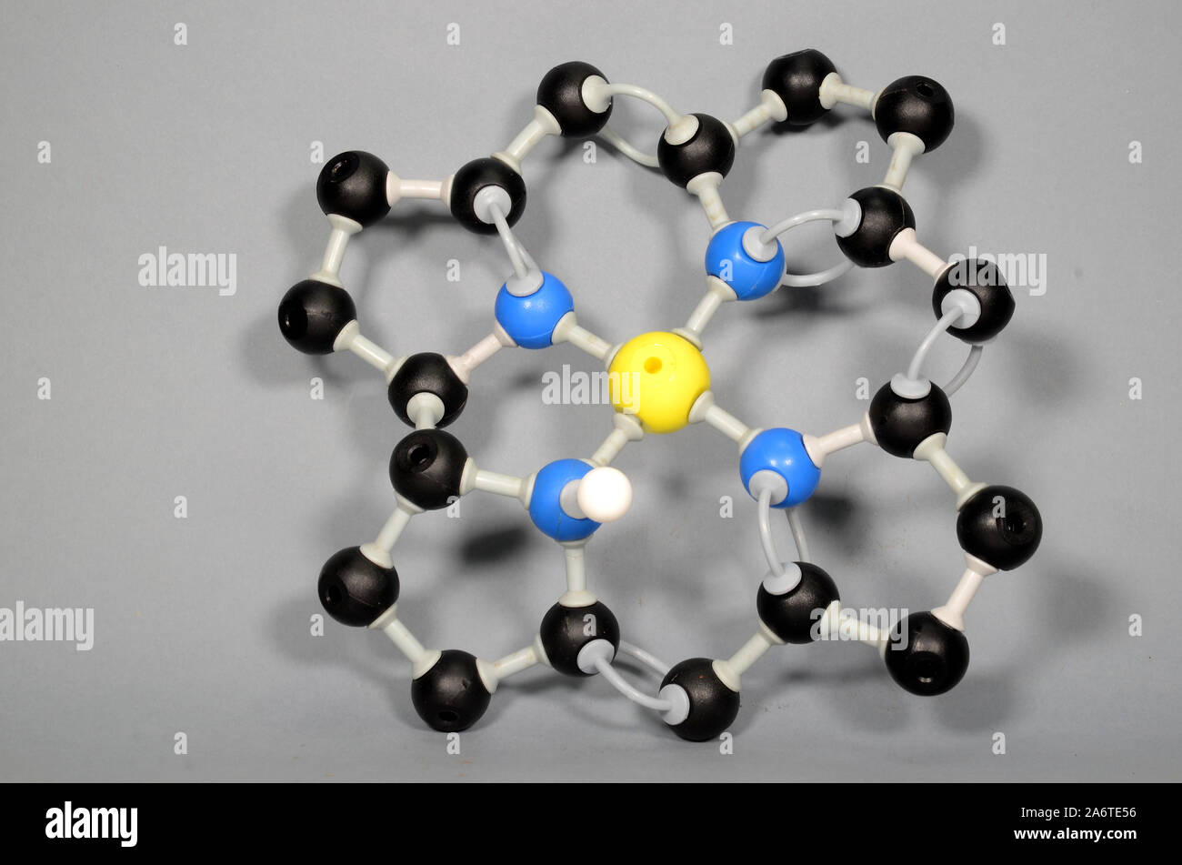 Molecule Model of a Corrin Ring. Black is Carbon, Blue is Nitrogen, Yellow may represent Cobalt or Iron. Stock Photo