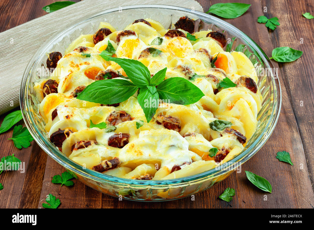 Potato casserole with sausage, cheese and basil Stock Photo