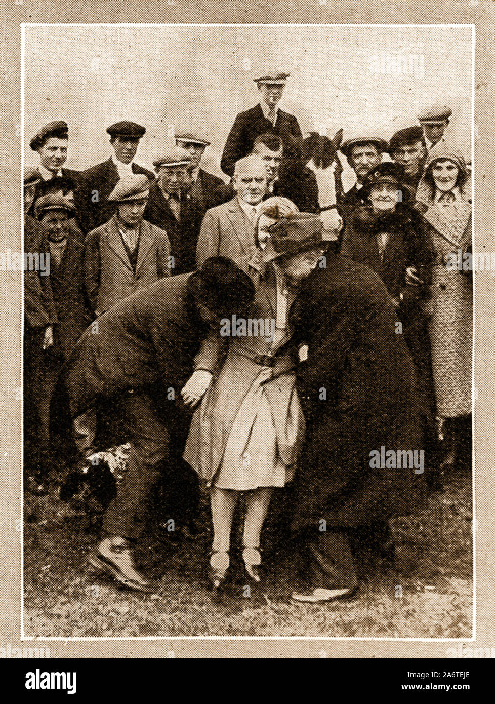 Traditional British often annual customs and ceremonies. - 1940's - Beating the Bounds ( marking the parish boundary at  Newbiggin, Northumberland. The person being dunted (bumped? on the boundary stone becomes a Freeman of the town (male or female). Similar ceremonies are still  held throughout Britain usually at Rogation-tide or ascension. Stock Photo