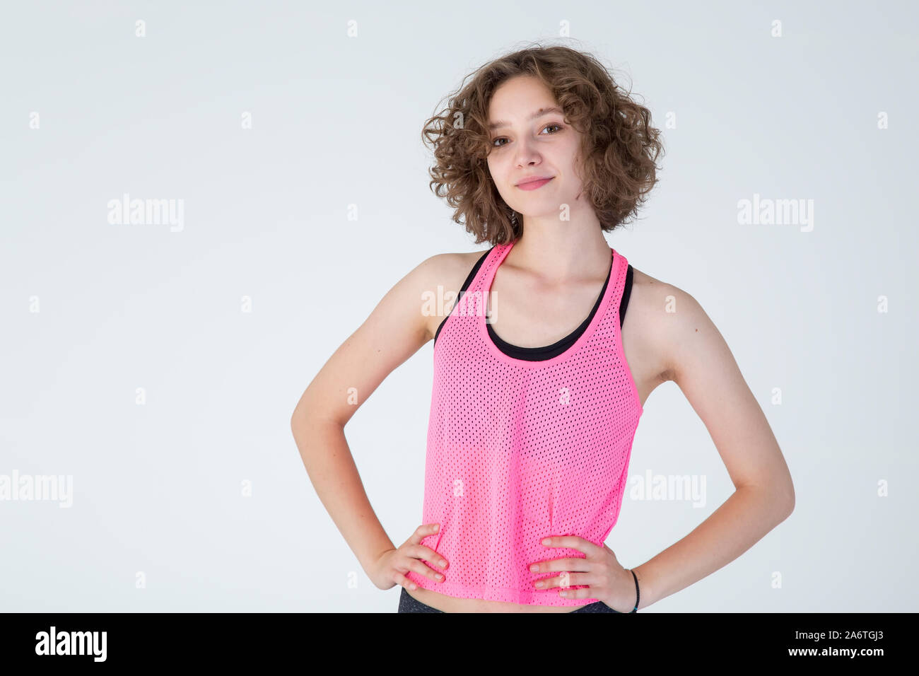 Premium Photo  Young beautiful woman with curly hair ready for gym on white