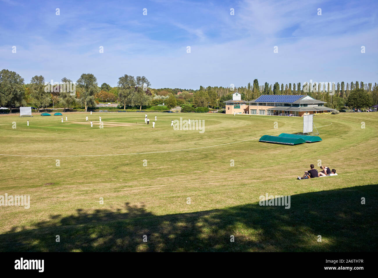 A game of cricket in progress at the Campbell Park cricket ground in Milton Keynes, Bedfordshire Stock Photo