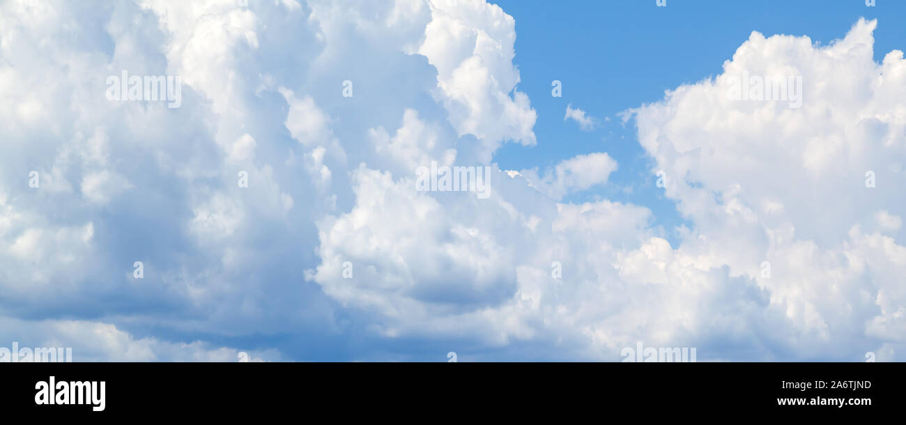 White cumulus clouds in blue sky at daytime. Natural panoramic ...