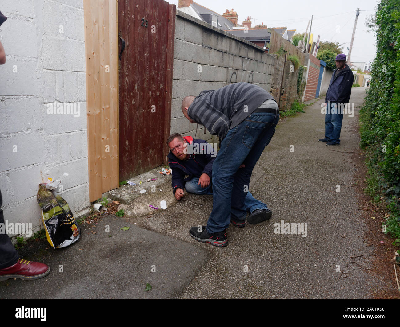 Newquay, Cornwall, England, 16th September 2019. Street drug user with National Health provided drug use kit collapses in the street.. Credit: Robert Stock Photo