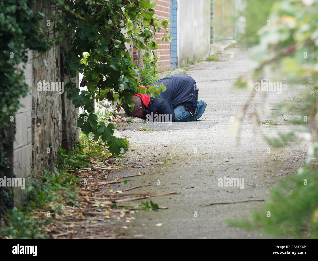 Newquay, Cornwall, England, 16th September 2019. Street drug user with National Health provided drug use kit collapses in the street.. Credit: Robert Stock Photo