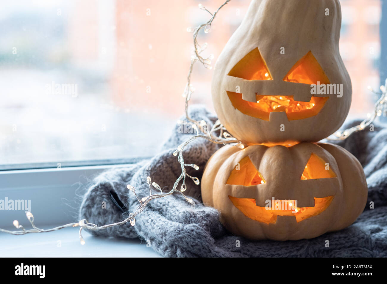 Jack o lanterns Halloween pumpkins face on a window Stock Photo - Alamy