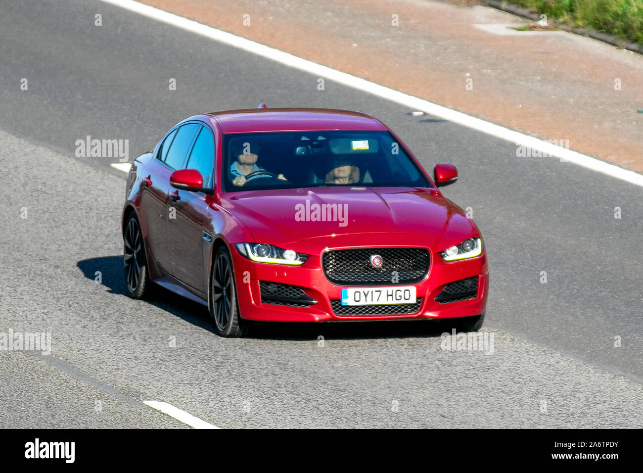 2017 red Jaguar XE R-Sport D Auto; UK Vehicular traffic, transport, modern vehicles, saloon cars, south-bound on the 3 lane M6 motorway highway. Stock Photo