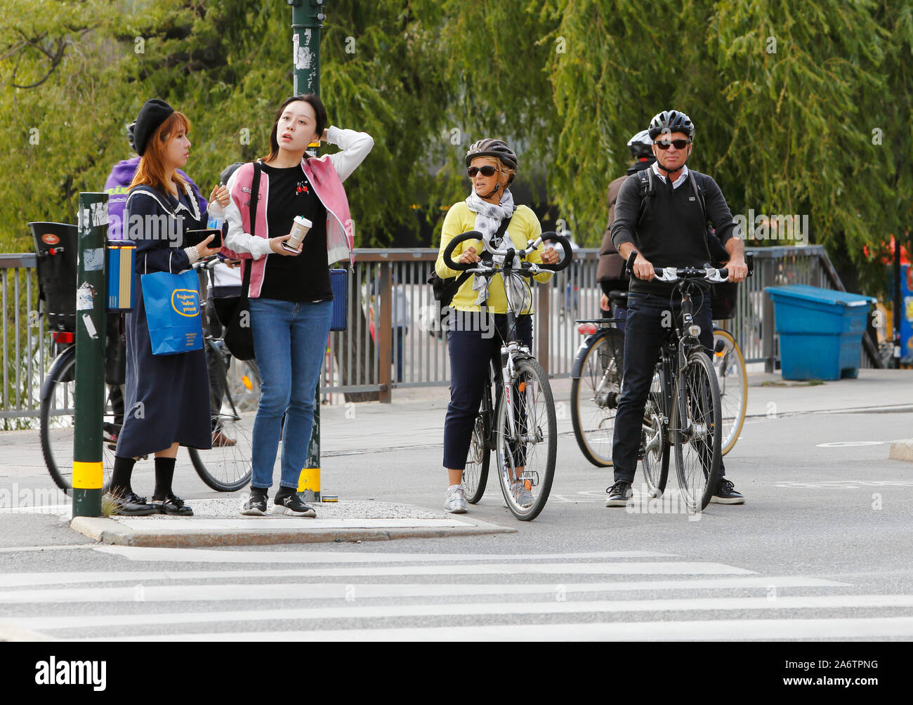 Stockholm, Sweden - September 10, 2019: People waiting for green light at a crosswalk. Stock Photo