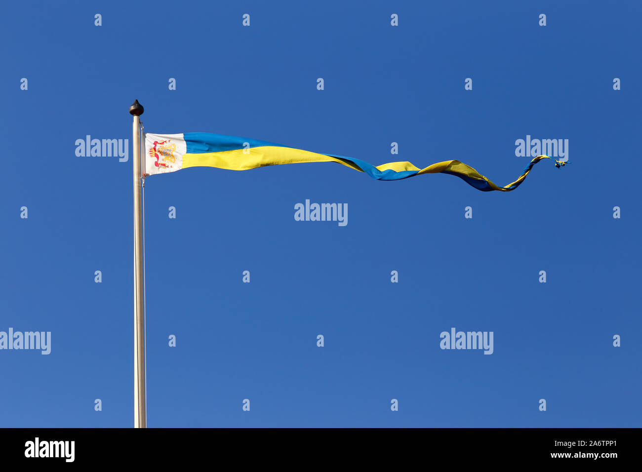 Mariefred, Sweden - September 12, 2019: Royal Swedish pennant hoisted at the Gripsholm castle against a blue clear sky. Stock Photo