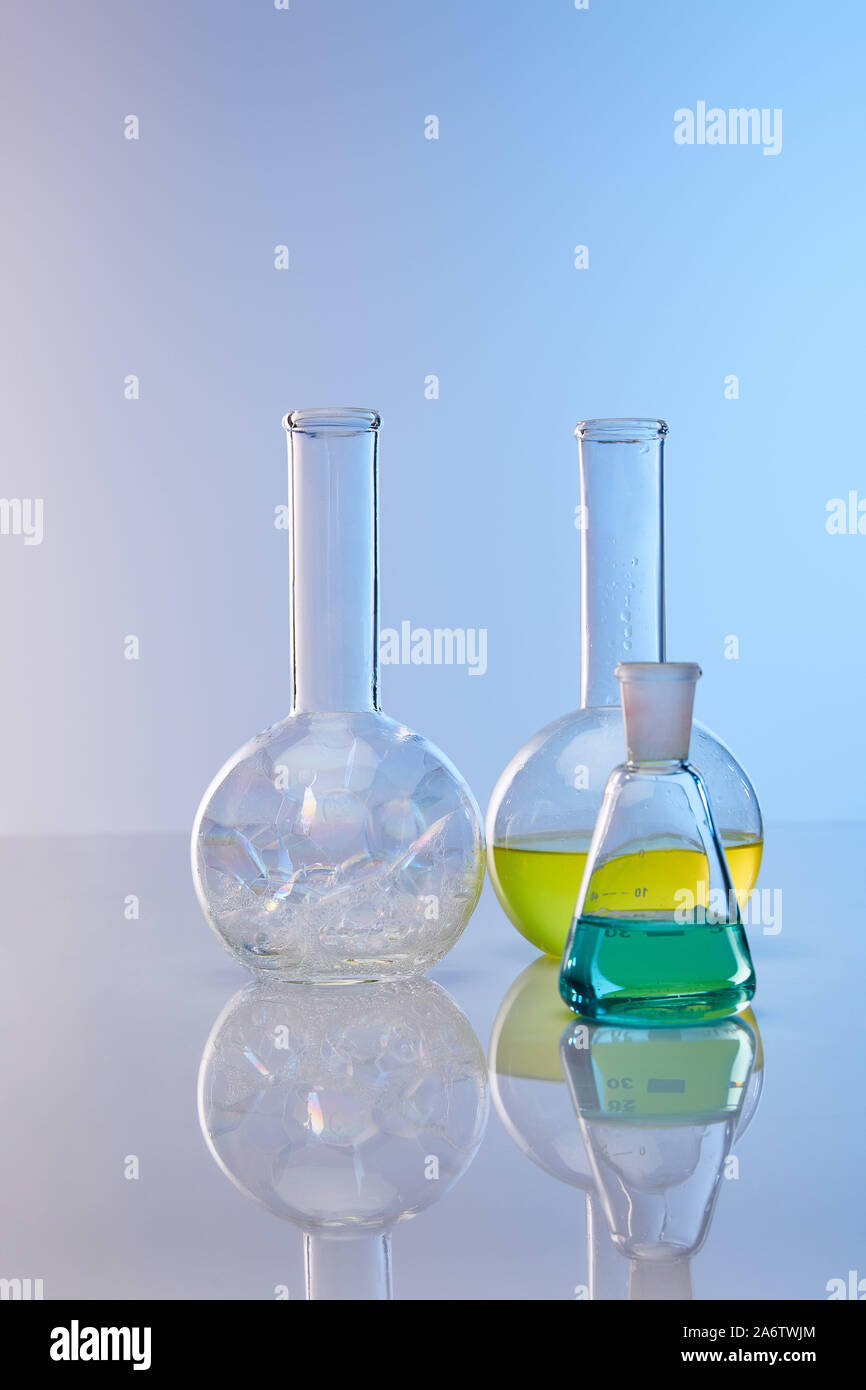 glass flasks with colorful yellow, blue liquid and bubbles Stock Photo ...