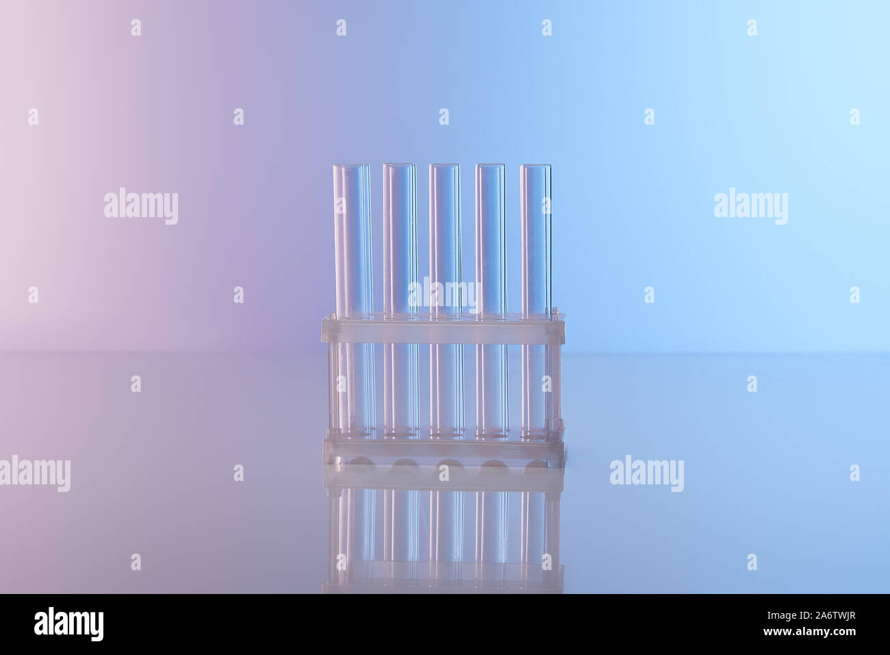 empty glass test tubes on blue background Stock Photo - Alamy