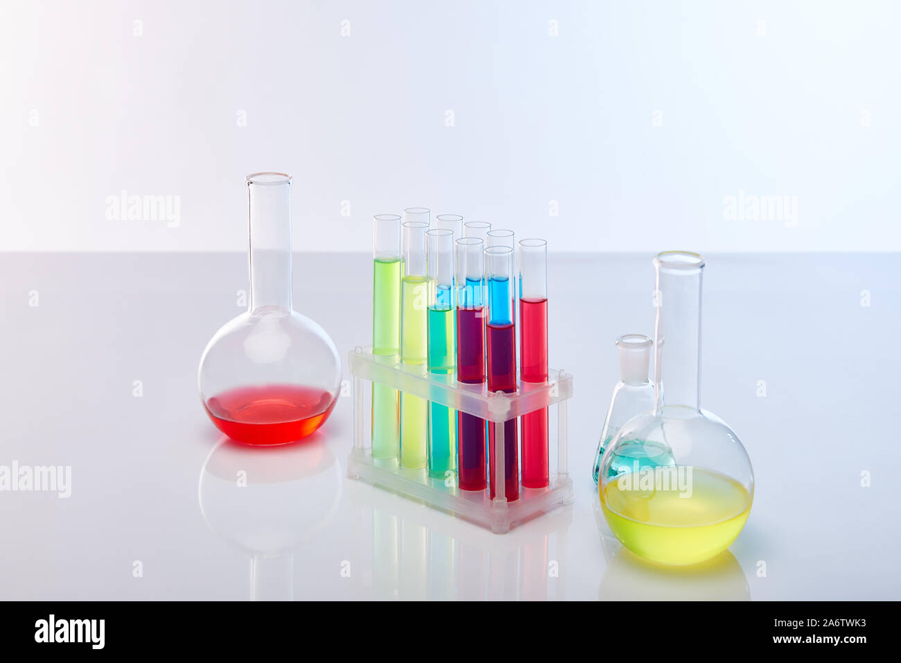 glass test tubes and flasks with colorful liquid isolated on white ...