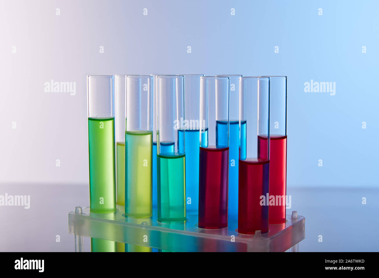 glass test tubes with colorful liquid on blue background Stock Photo ...