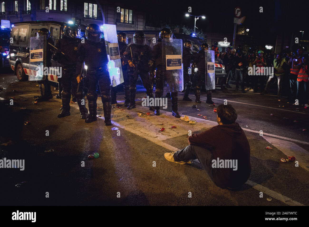 Protester sits in front of a police group during police charges in Via Laietana, Barcelona, Spain Stock Photo
