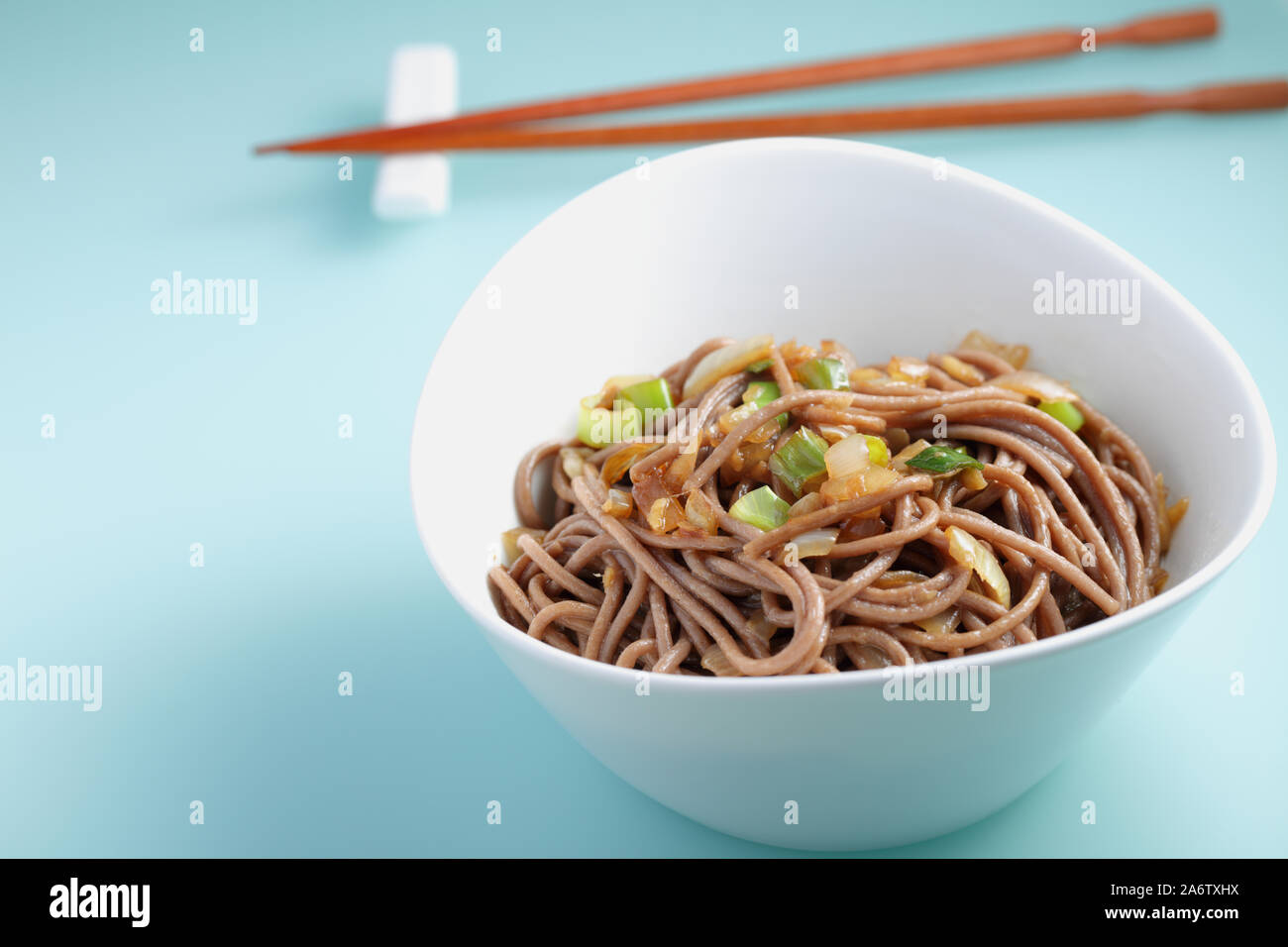 Bowl of soba noodles with fried green onions Stock Photo