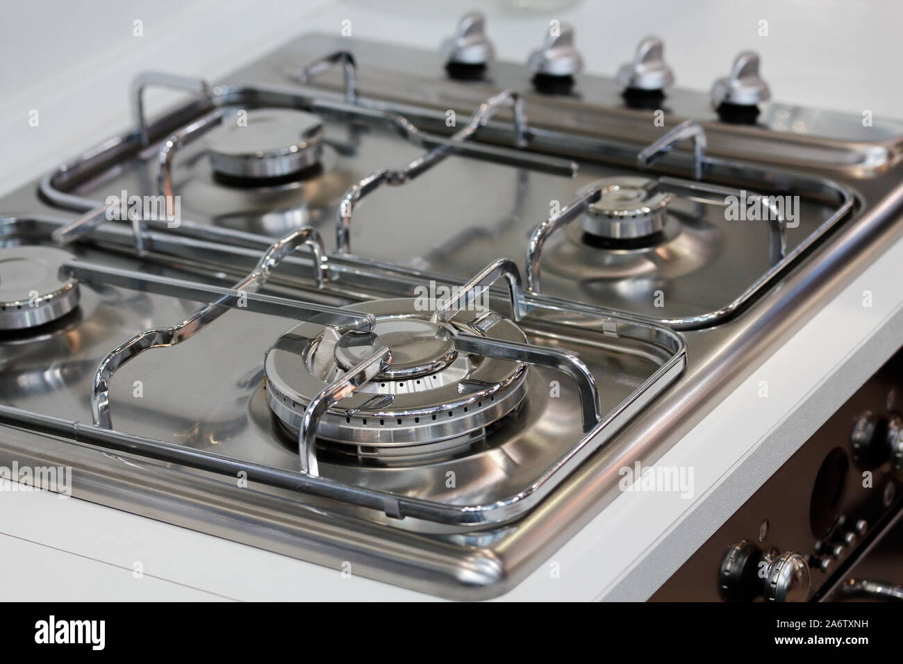 Stainless steel upper part of a gas cooking range. Selective focus. Stock Photo