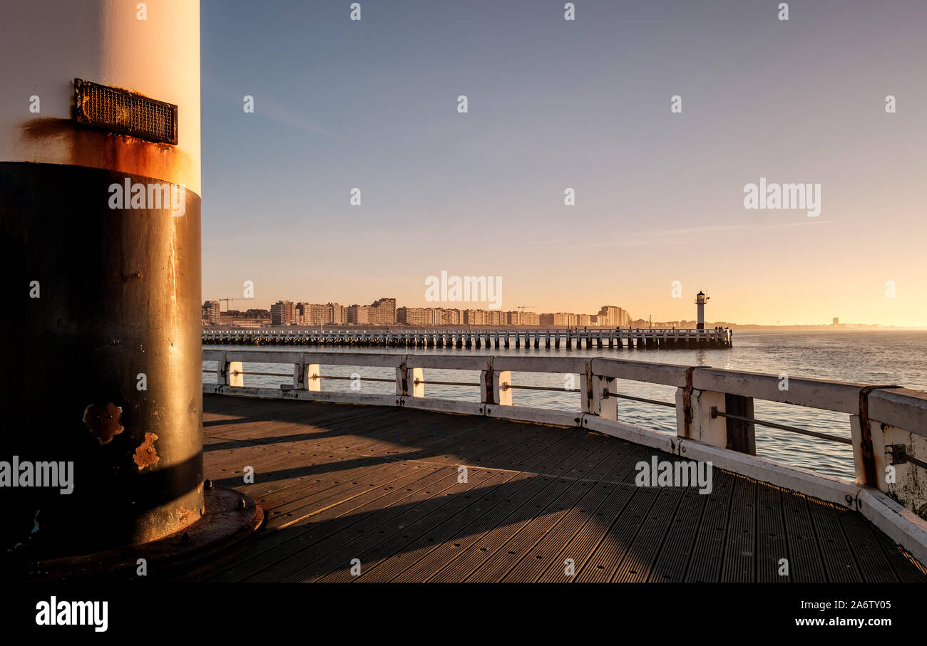 Old Nieuwpoort pier and lighthouse at sunset Stock Photo