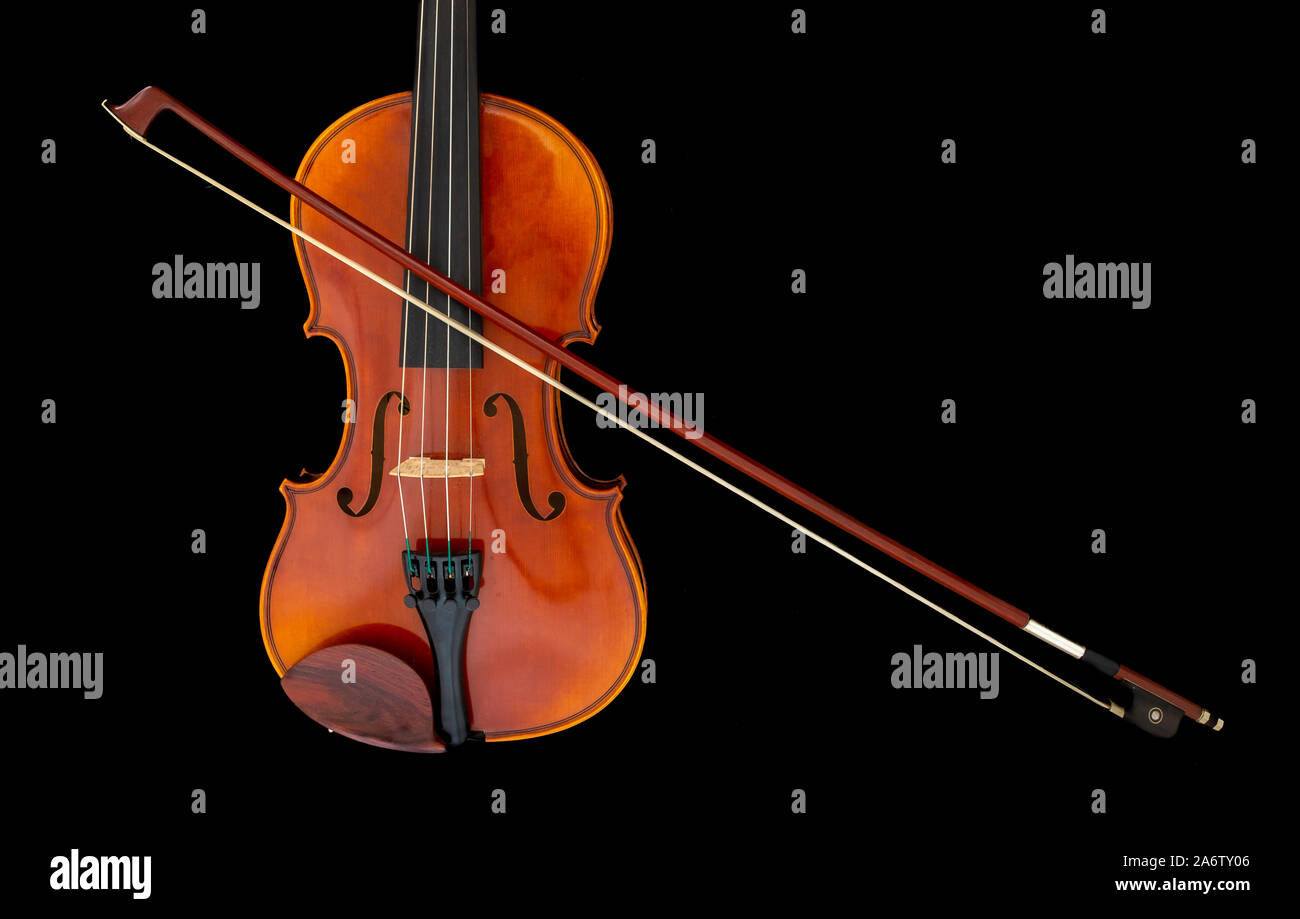 Child's violin with bow isolated on black background Stock Photo