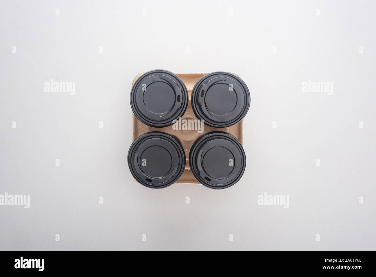 top view of paper cups with coffee in cardboard tray on white ...