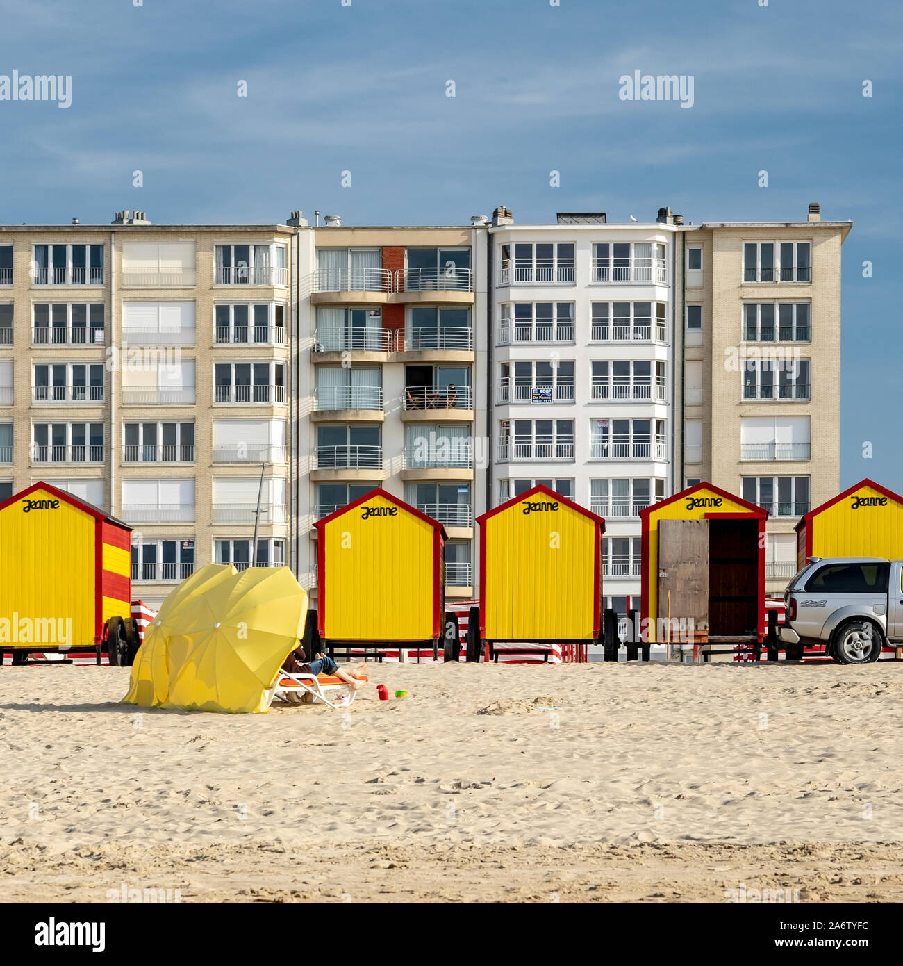 De Panne, Belgium - 18 April 2019: beach parasols and vintage beach huts. Stock Photo