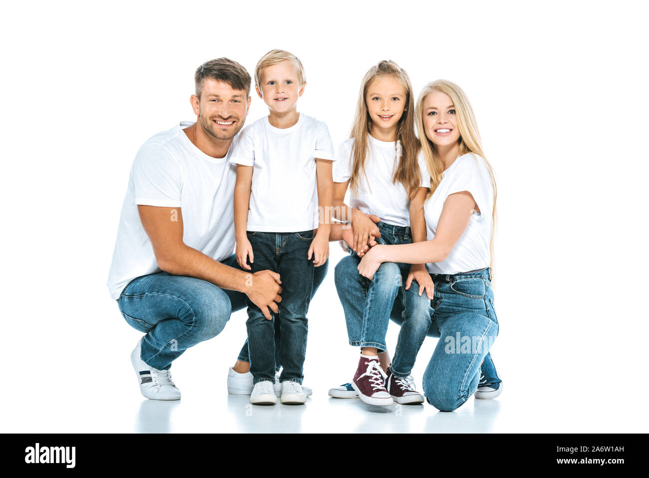 happy family in blue denim jeans looking at camera on white Stock Photo