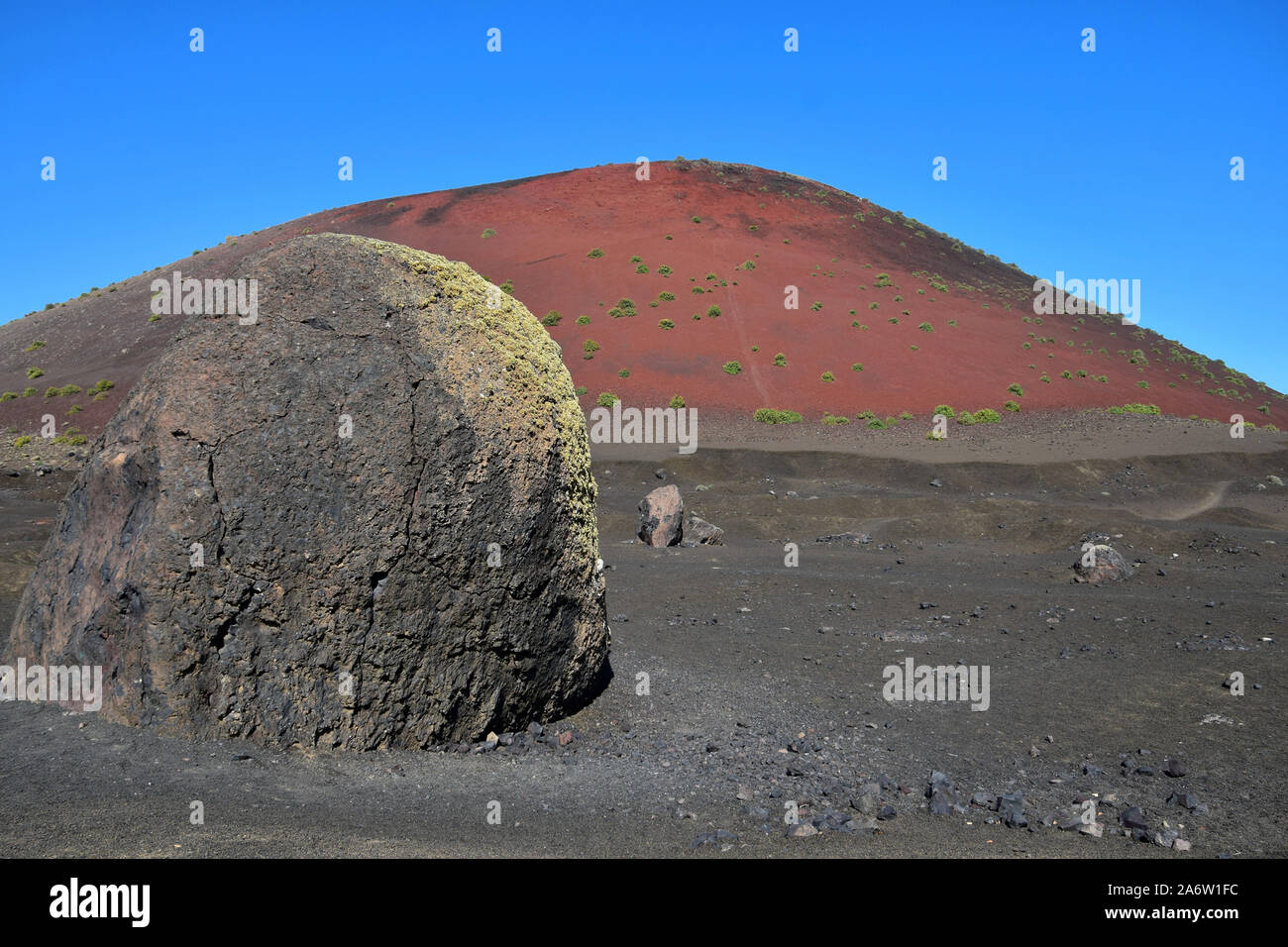 The big lava bomb near the red volcano Montana Colorada in Lanzarote, Spain. Stock Photo