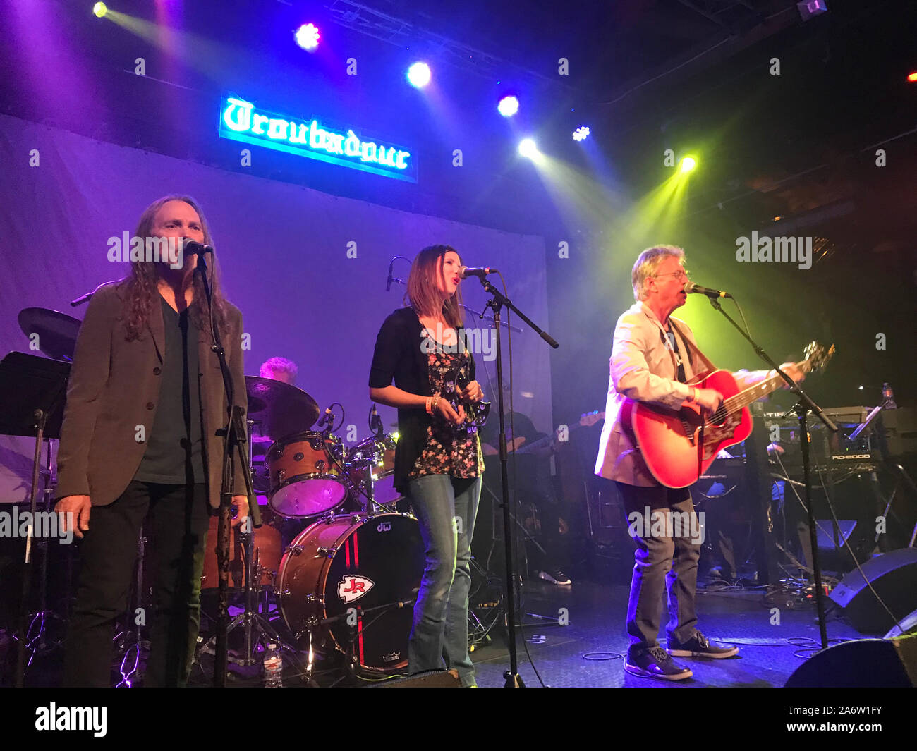 Richie Furay (right) and Timothy B. Schmidt (left)accompanied by Furay's daughter singing (center) at the Troubadour in Los Angeles circa 2019. Stock Photo