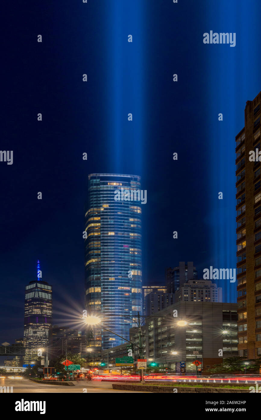 A NYC 911 Tribute In light - View to One World Trade Center, commonly known as the Freedom Tower and to lights beamimg high in the twilight sky at the Stock Photo