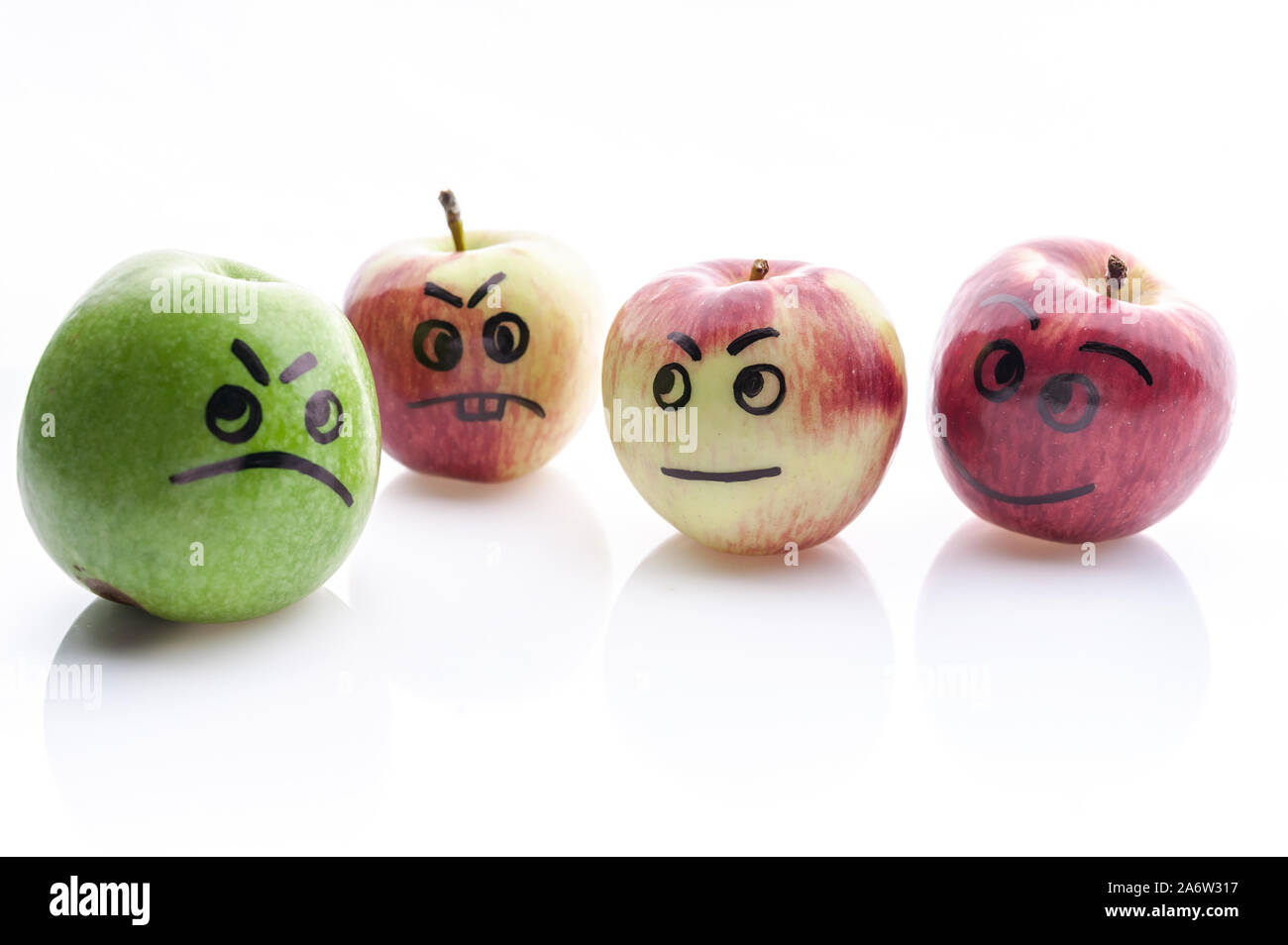 Face painted apples. Jolly and sad funny apples. Green and red apples