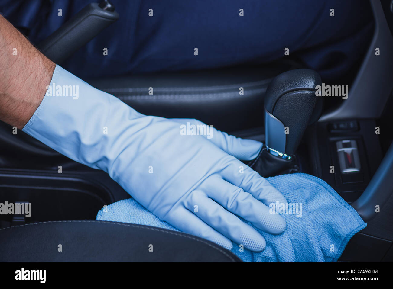 cropped view of car cleaner wiping gear shifter with rag Stock Photo