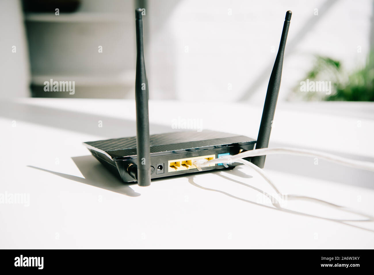 black plugged router on white office table in sunshine Stock Photo - Alamy