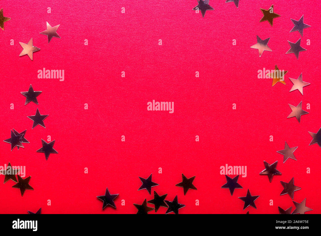 Gold stars on bright red background, abstract image Stock Photo