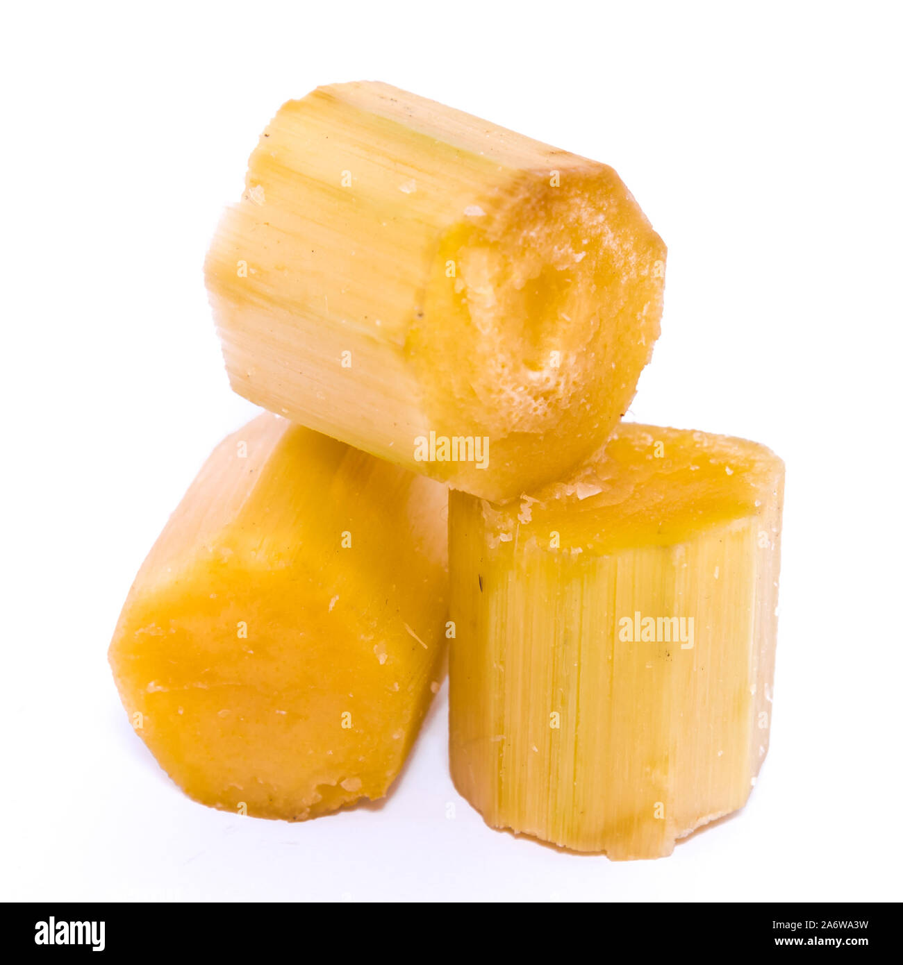 Studio shot three peeled sugar cane sticks isolated on white Stock