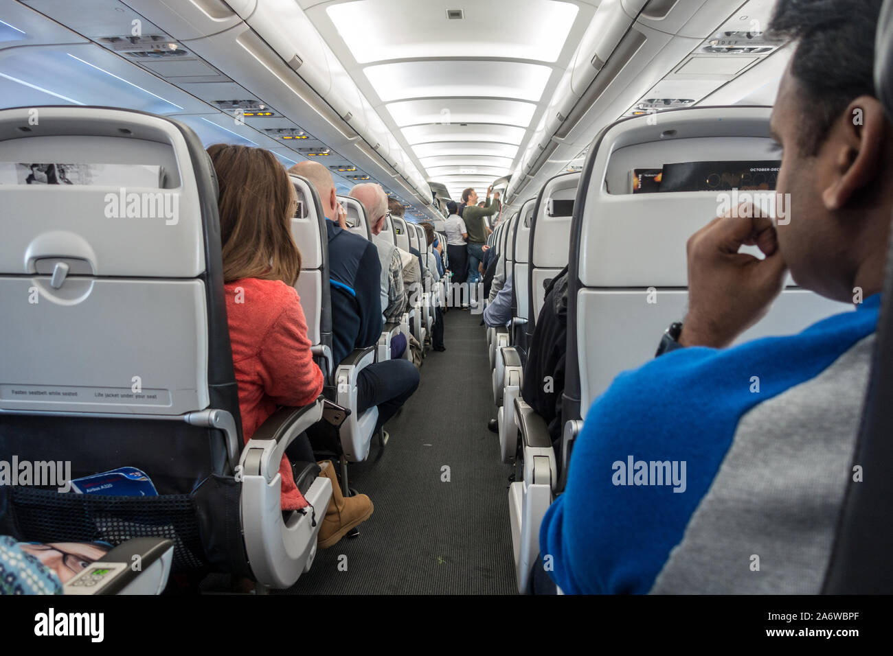 A view down the aisle of an airliner prior to takeoff. Stock Photo
