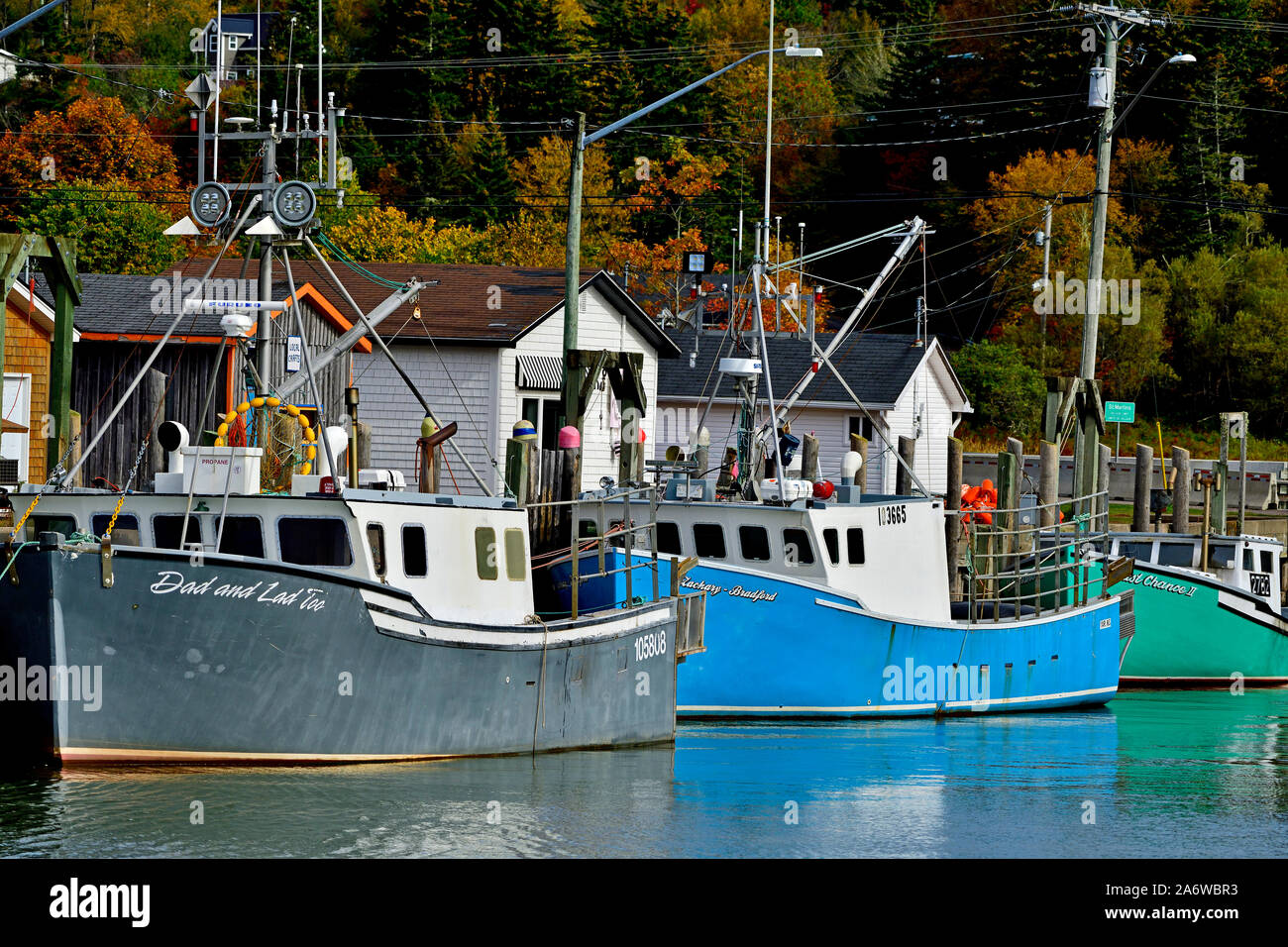 Three east coast fishing boats moored to the warf in Saint Martins New Brunswick Canada. Stock Photo