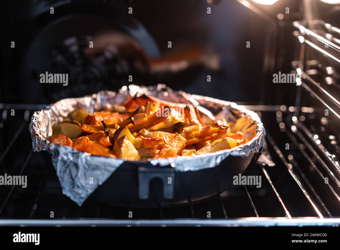 Baked potatoes with carrot and other spices in roasting pan Stock Photo Alamy