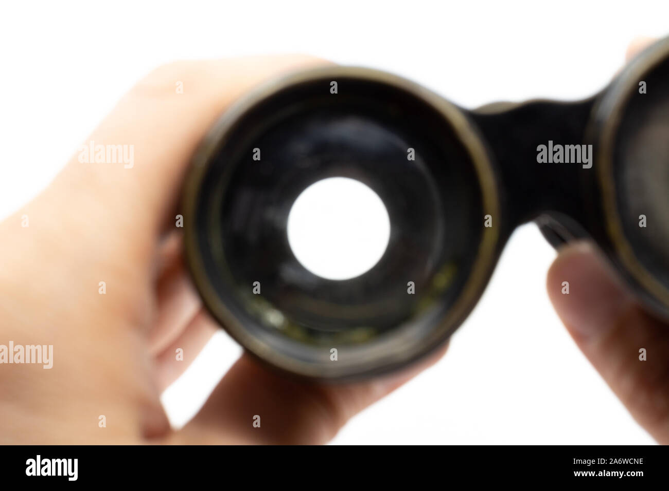 Looking through opera glasses binoculars while hand holding it Stock Photo