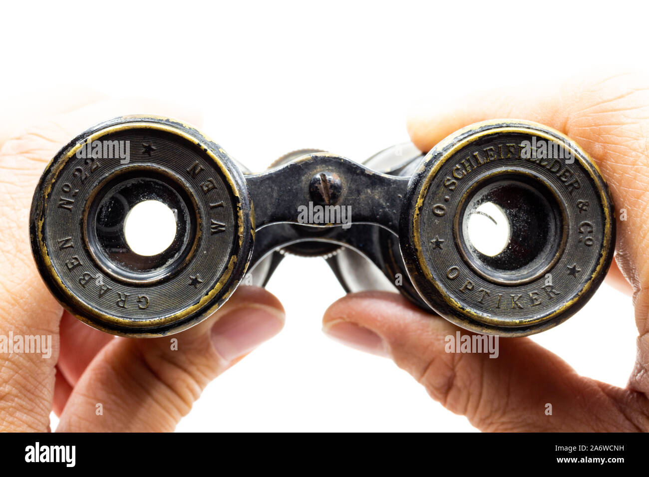 Looking through vintage opera glasses made by the famous Austrian optician Otto Schleiffelder early 20th century Stock Photo