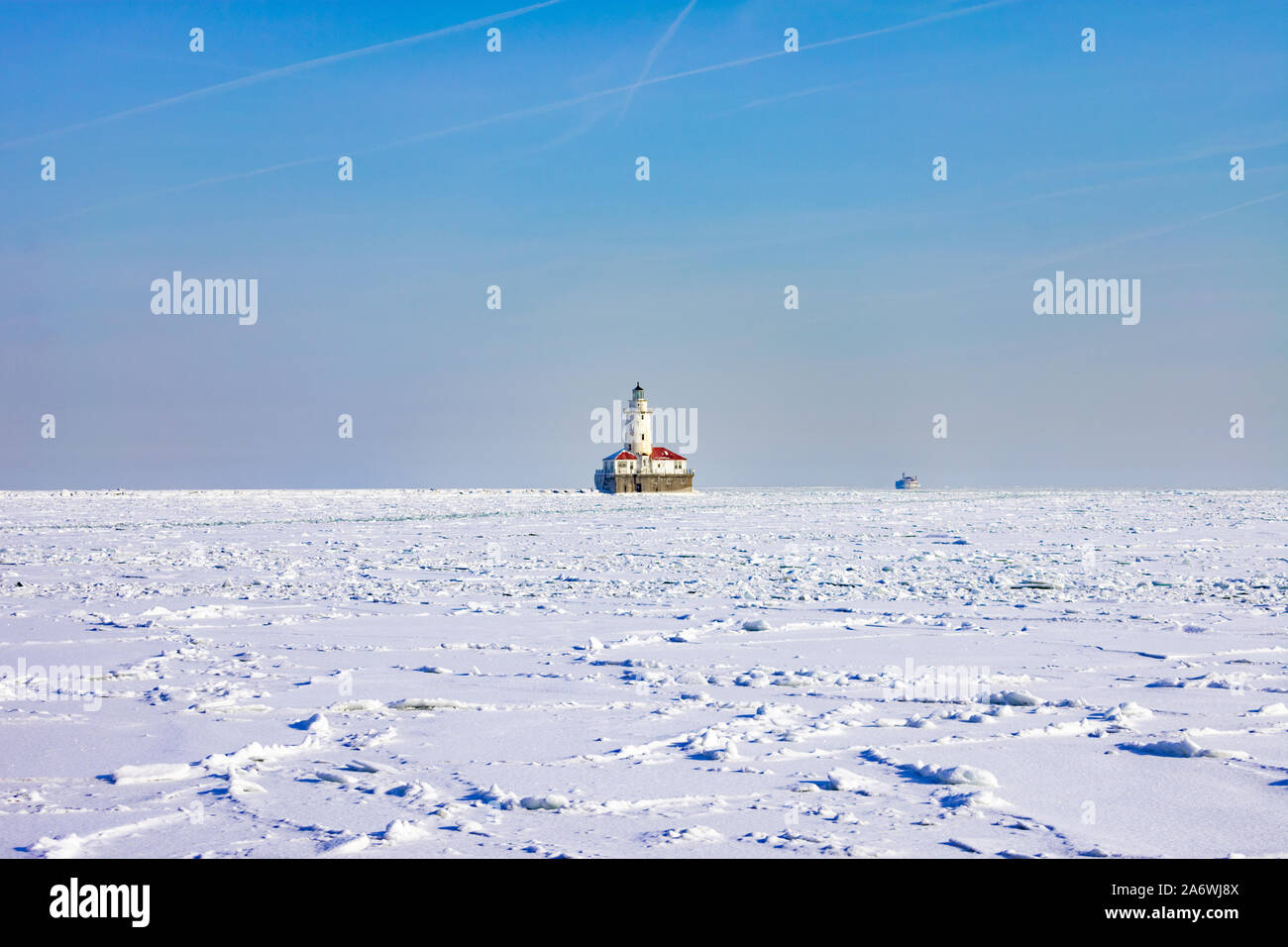 Chicago Harbor Lighthouse on a Frozen and Snow Covered Lake Michigan after a Polar Vortex Stock Photo