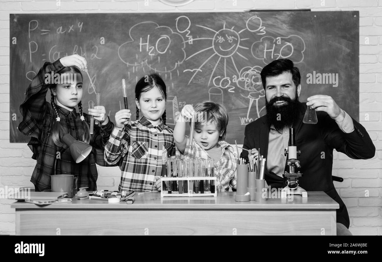 Scientists at work. students doing science experiments with microscope in lab. back to school. kids scientist studying science. happy children. Little kids learning chemistry in school laboratory. Stock Photo