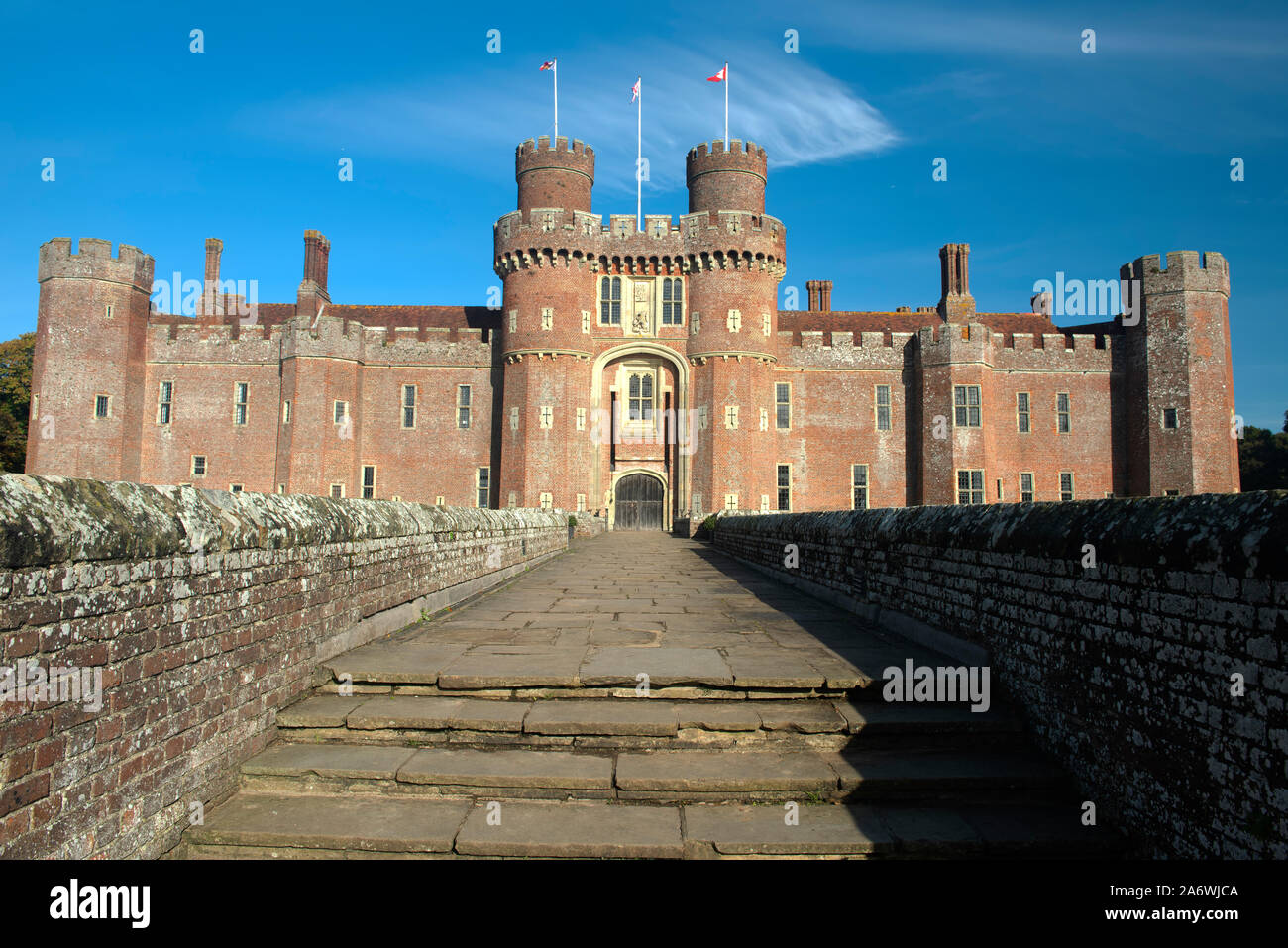 Herstmonceux Castle, a 15th century moated red brick structure, on a bright autumn morning, near Hailsham, East Sussex, England, UK Stock Photo