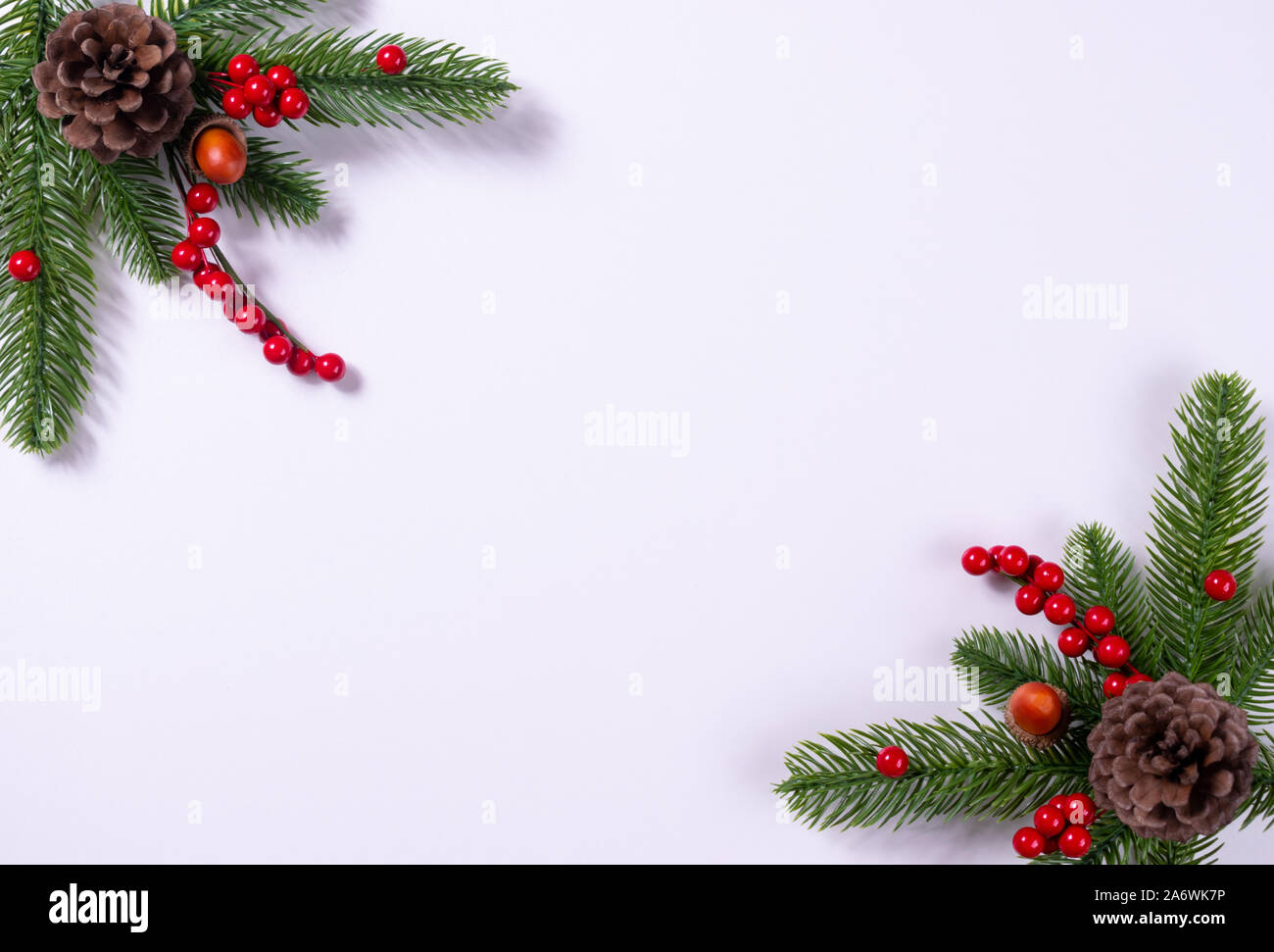 Christmas background with fir branches, pine cone and holly berries ...