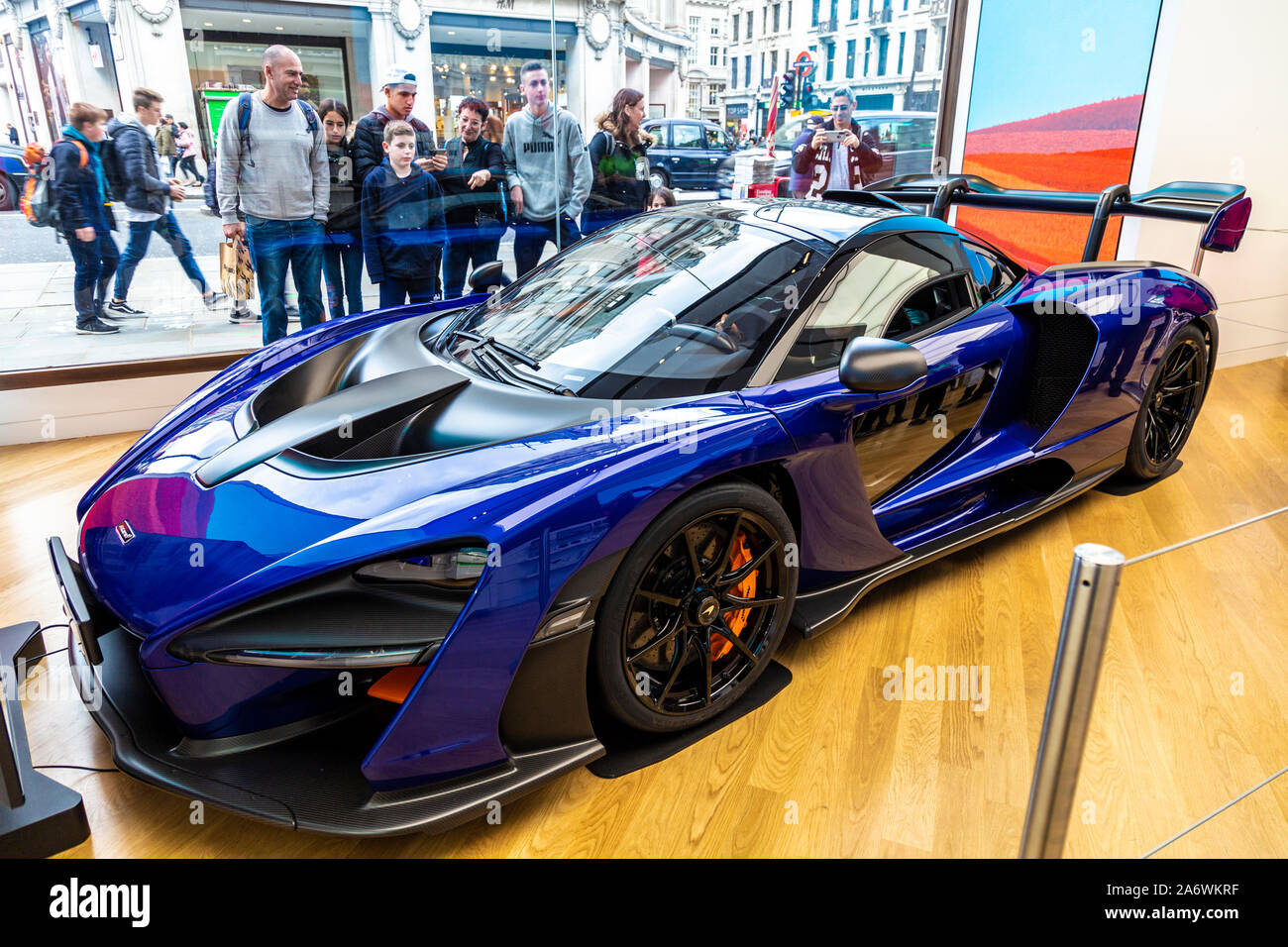 October 2019 - People admiring the McLaren Senna car through the shop window at the Microsoft store in Oxford Circus, London, UK Stock Photo