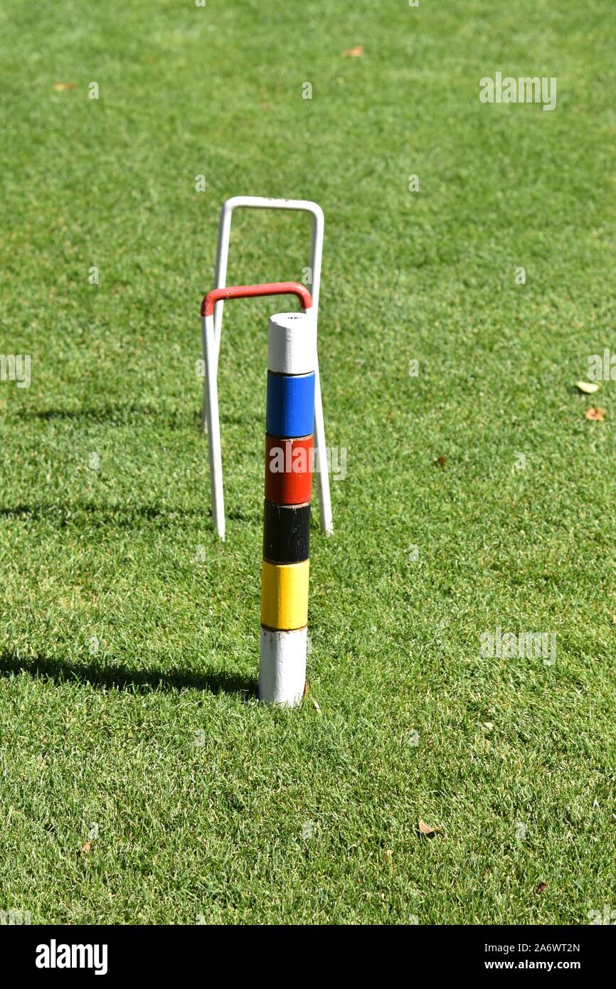Croquet wickets and colors in the grass Stock Photo