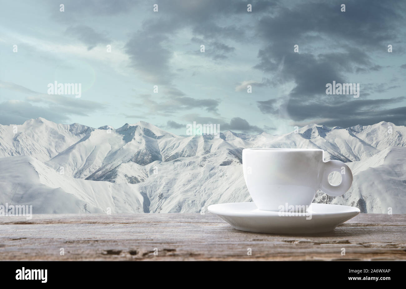 https://c8.alamy.com/comp/2A6WXAP/single-tea-or-coffee-mug-and-landscape-of-mountains-on-background-cup-of-hot-drink-with-snowly-look-and-cloudly-sky-in-front-of-it-warm-in-winter-day-holidays-travel-new-year-and-christmas-time-2A6WXAP.jpg