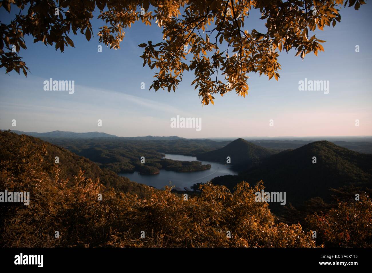 A beautiful scenery of green mountains near a lake surrounded by green ...