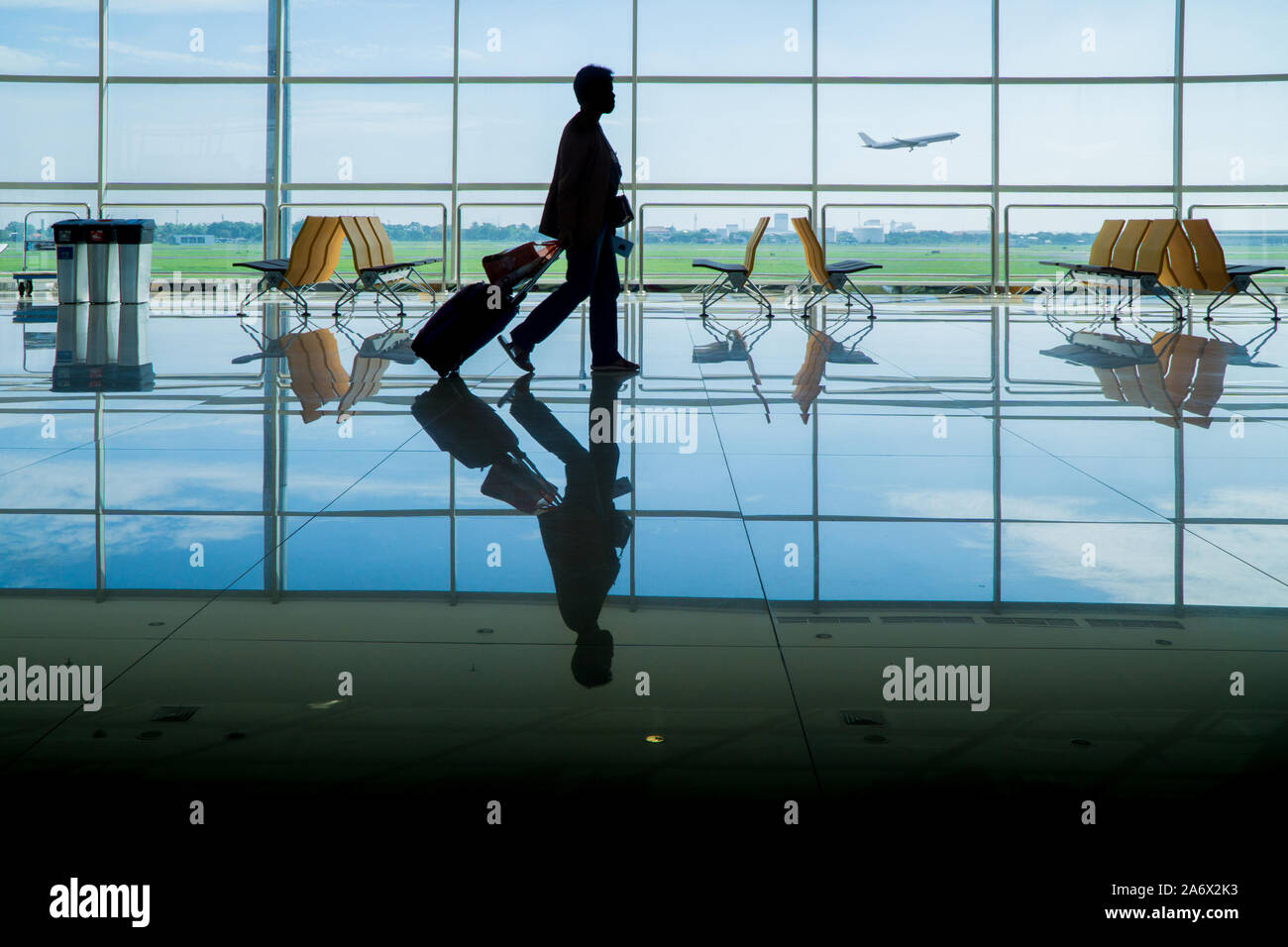 Unrecognizable woman or man businessman businesswoman walking to boarding gate before departure at the airport Stock Photo