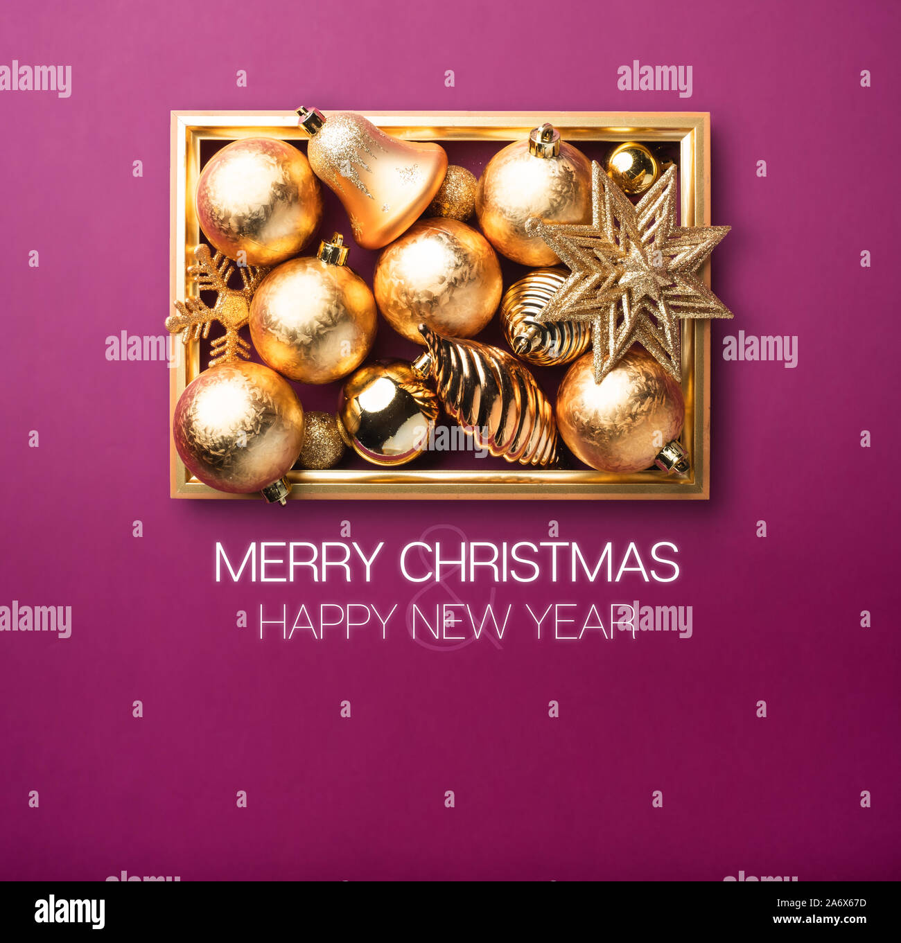 Merry Christmas and happy new year.Shiny gold Christmas decoration ball and star with golden frame in purple luxury background.holiday celebration gre Stock Photo