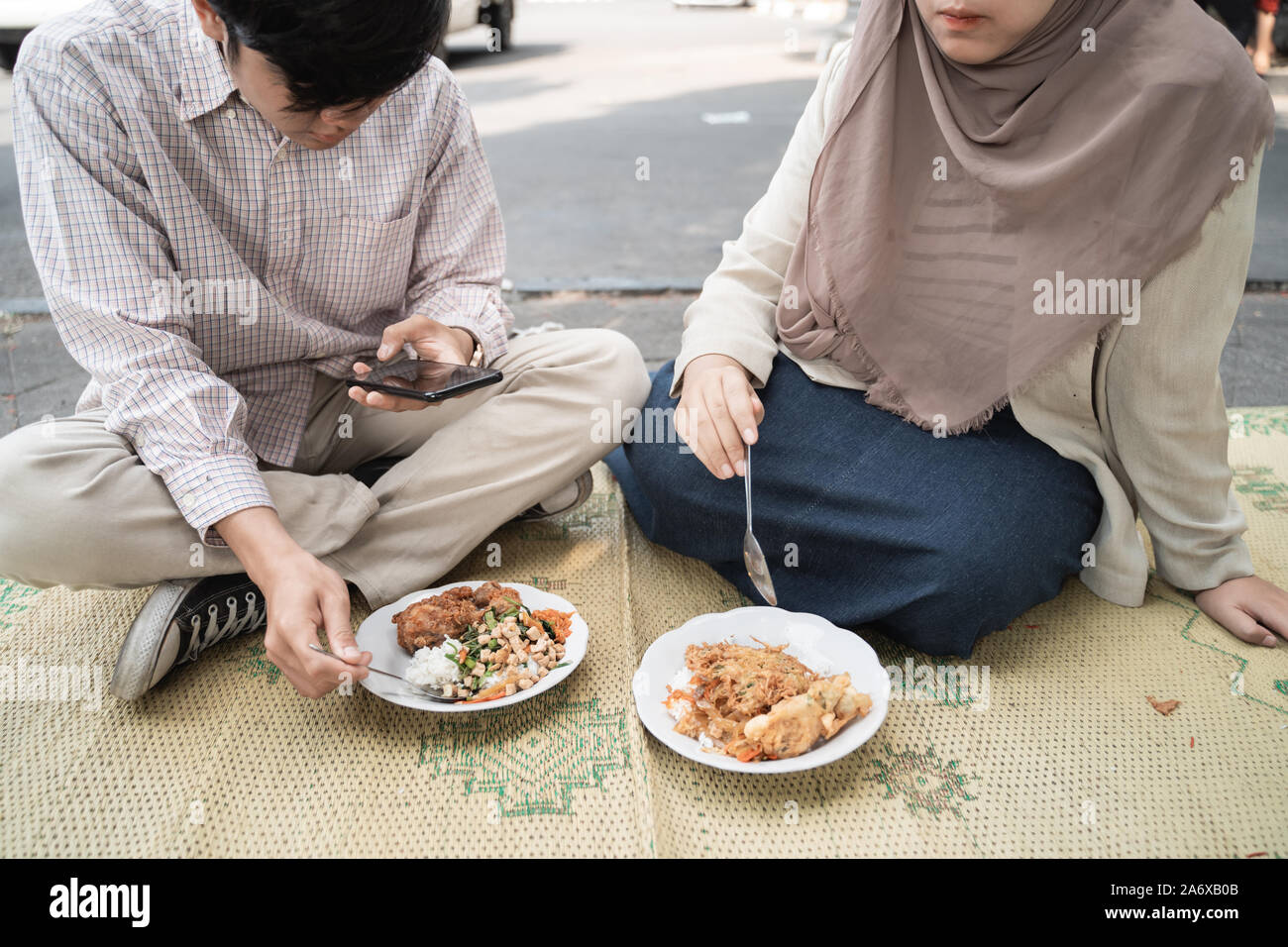 portrait of couple eat traditional food of indonesia is nasi rames Stock Photo