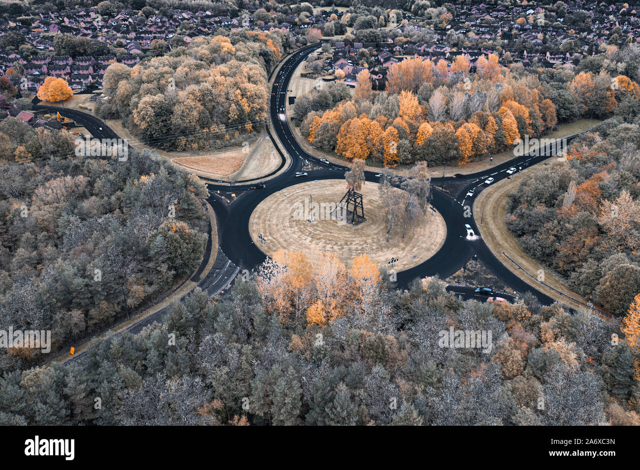 Aerial view over British suburban area with circular junction at autumnal evening. Telford in United Kingdom Stock Photo